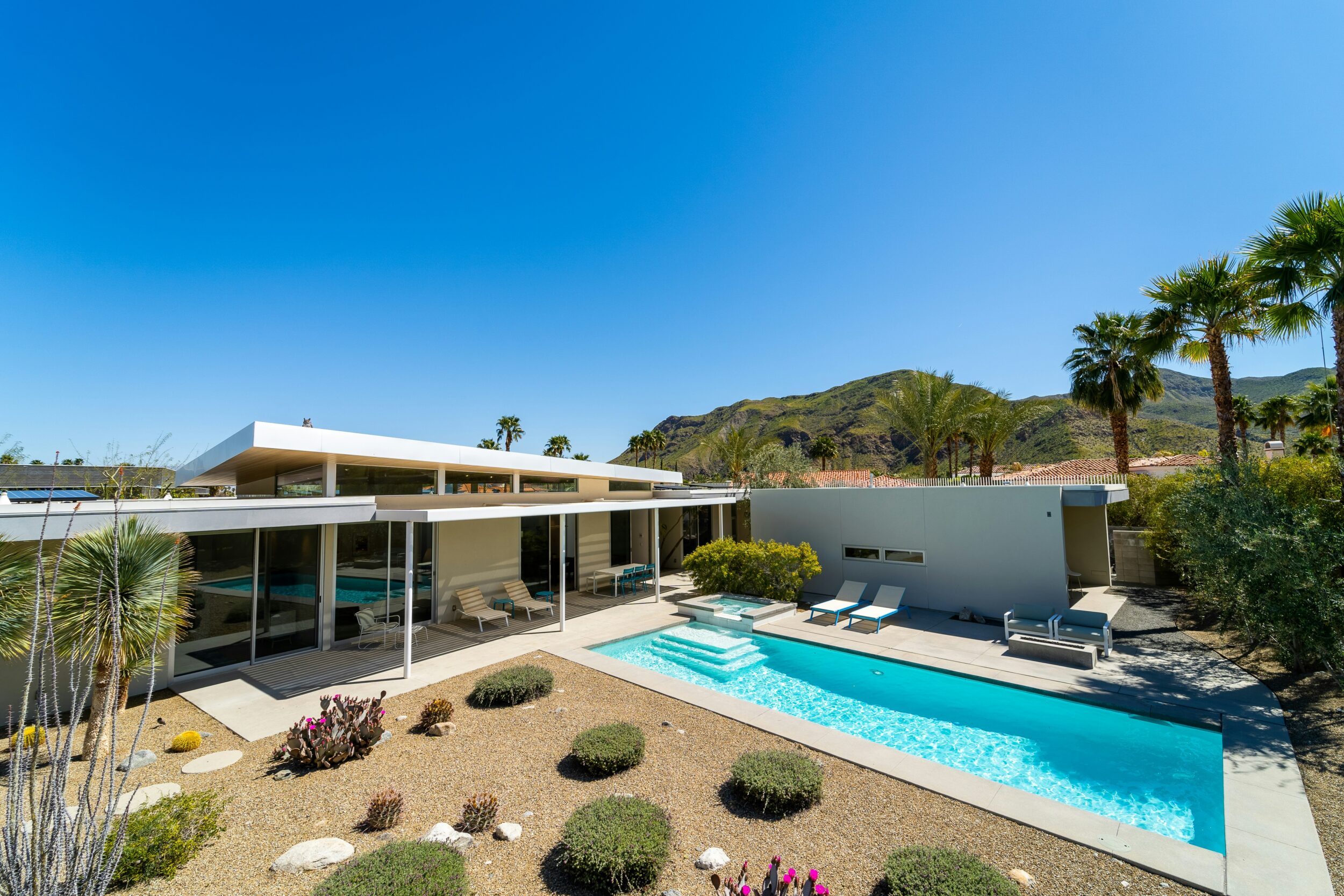 Aerial view of a Mid-century Modern Home exterior featuring an outdoor pool. Image credit Cesar Cid on Unsplash.