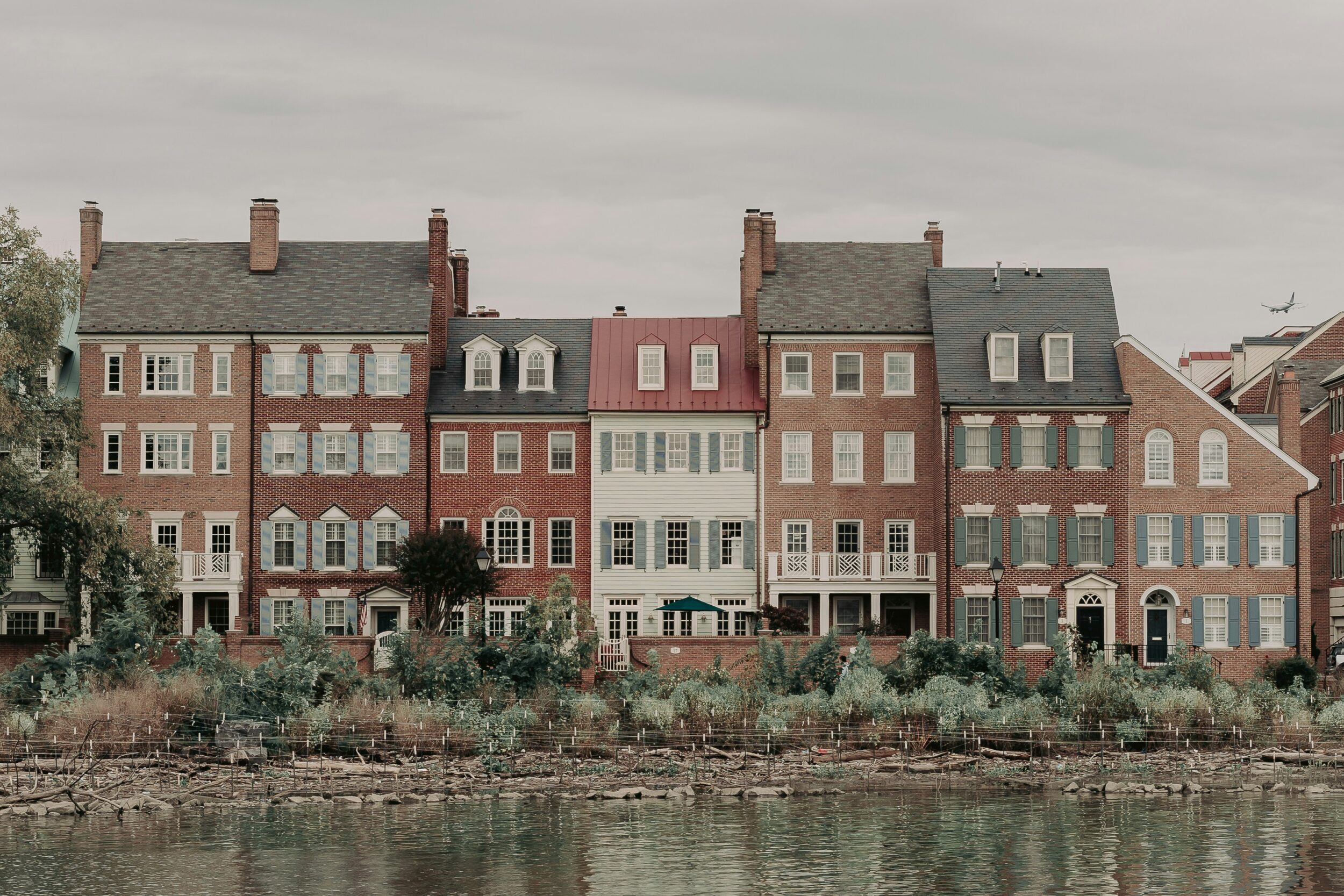 Example of a townhouse-style building, featuring multi-story structures with brick and wood paneling. Image credit Jack Prommel on Unsplash.