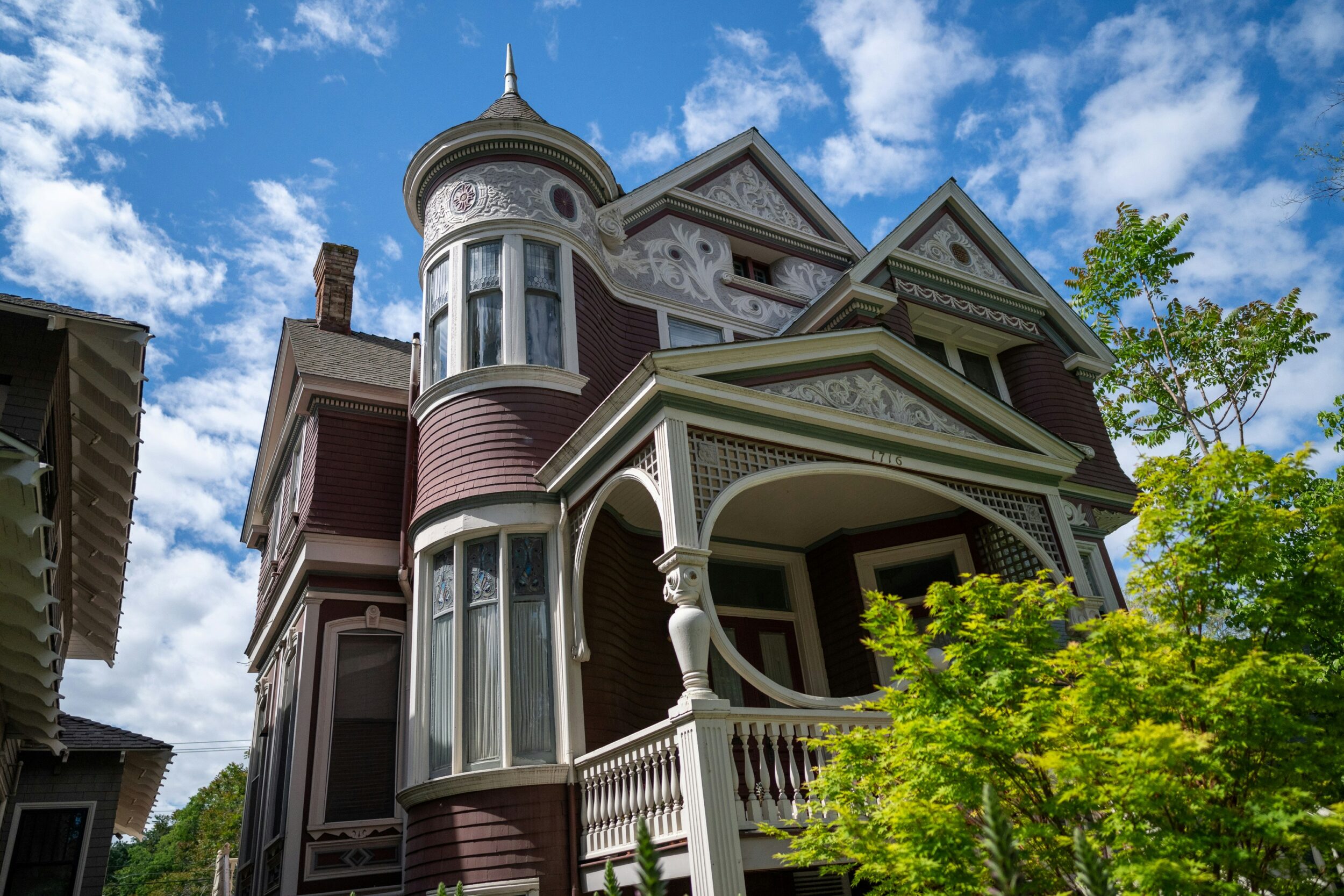 Exterior shot of Victorian Style Home seen with defining features like intricate woodwork. Image credit Michael Kahn on Unsplash.